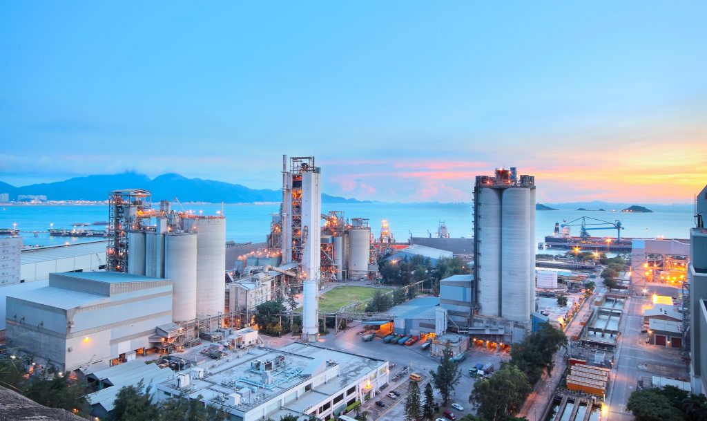 Industrial plant at dusk with process towers and silos