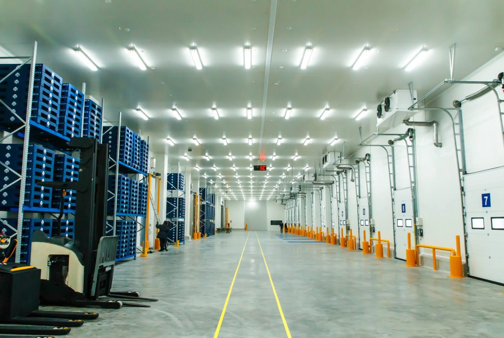 High racks in a distribution warehouse under bright even lighting