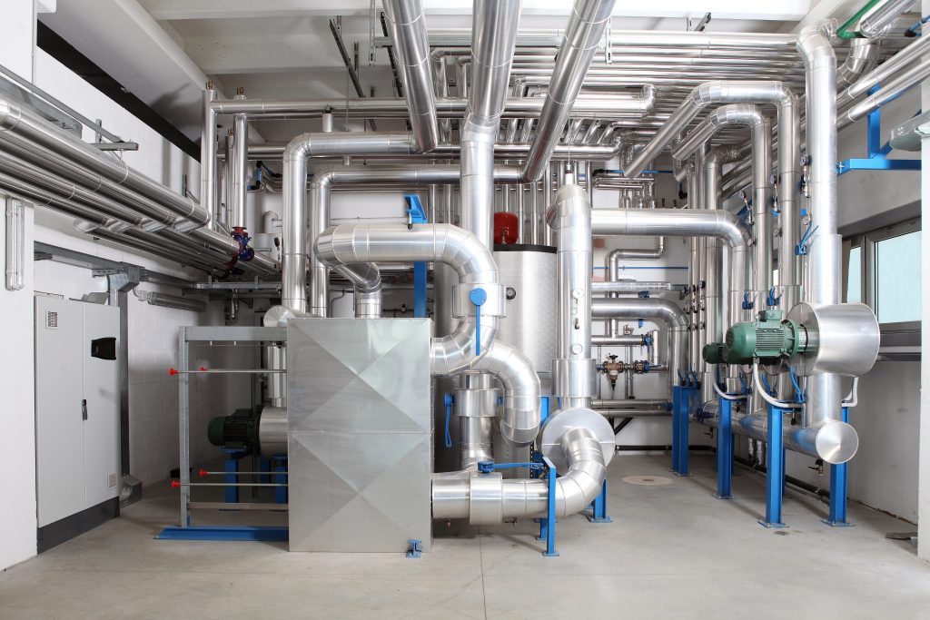 Industrial refrigeration compressors and piping in a plant room