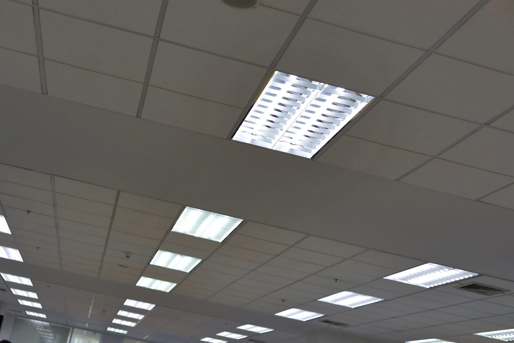 Ceiling-mounted sensors and controlled lighting in an office